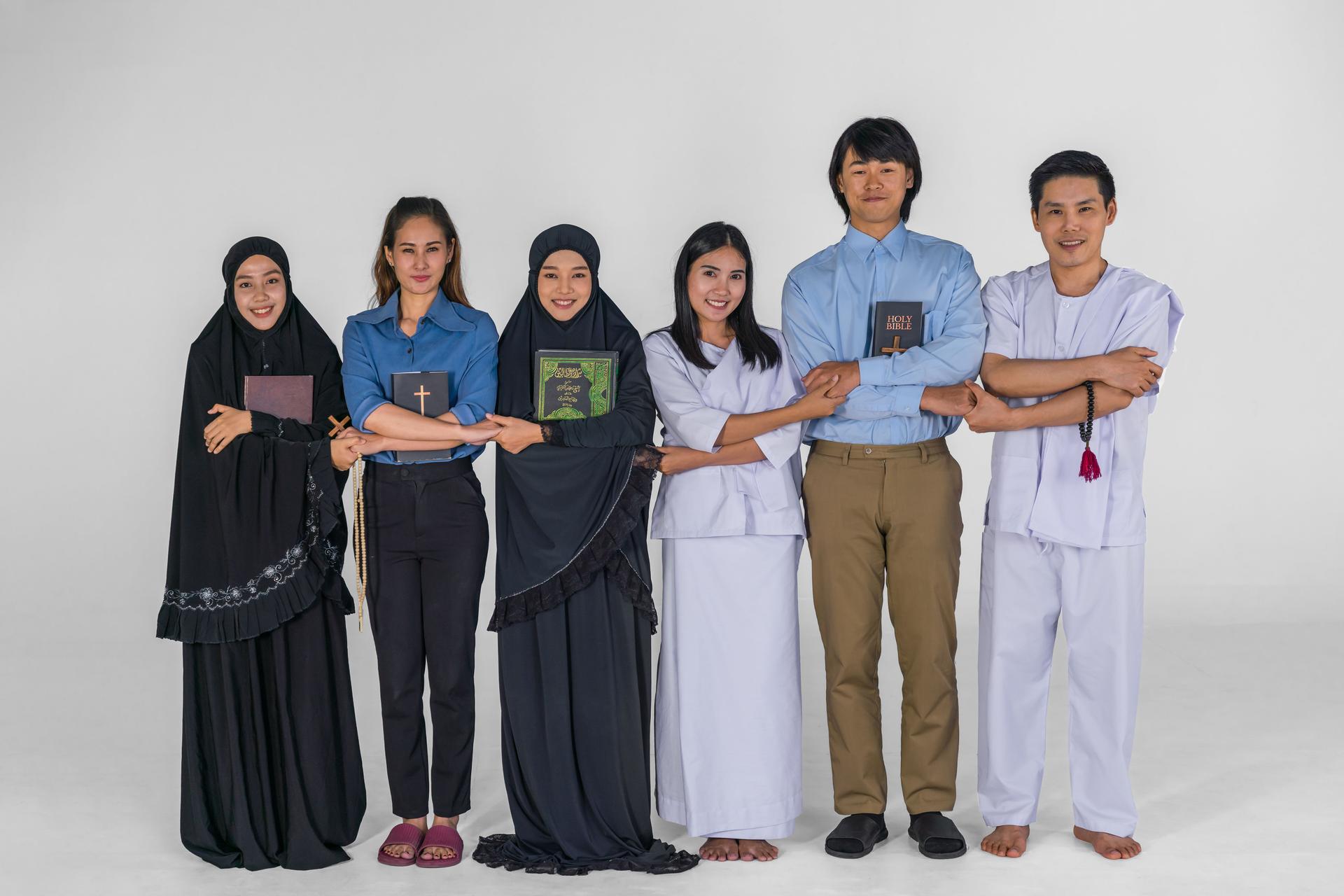 portrait of multicultural group of diverse religious asian people Christian Buddhist and muslim posing together showing inclusive teamwork and cooperation