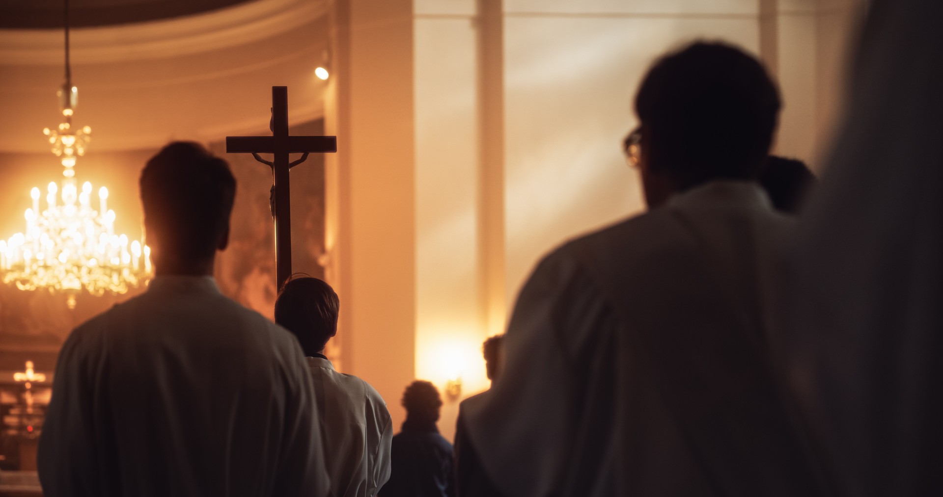 Liturgy In Church: Procession Of Ministers, Bearing Holy Cross to Altar, As Congregation Stands In Wonder. Christians Rejoice In Celebration Of Divine Mass. Hymns Praise God